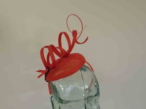 Pillbox fascinator with sinamay swirls in persimmon orange