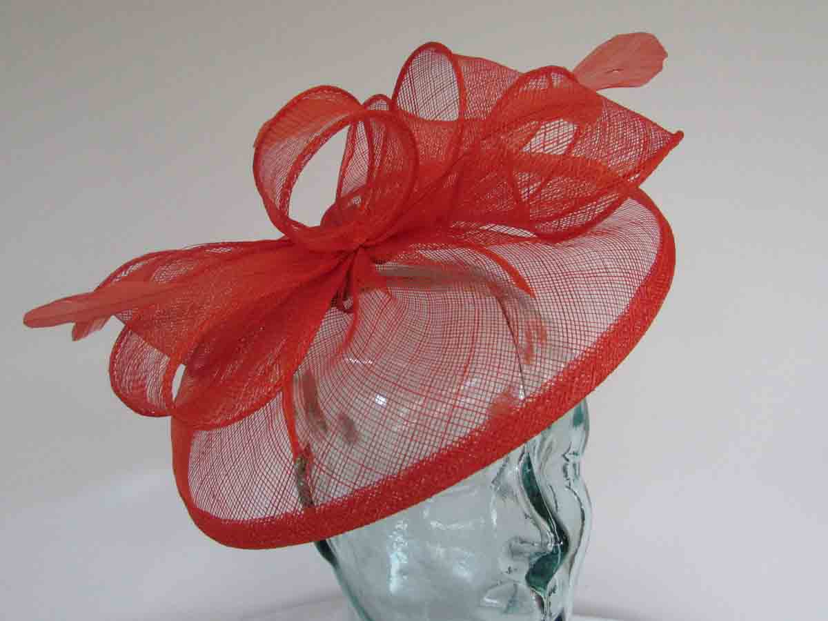 Sinamay fascinator with feathers in persimmon orange