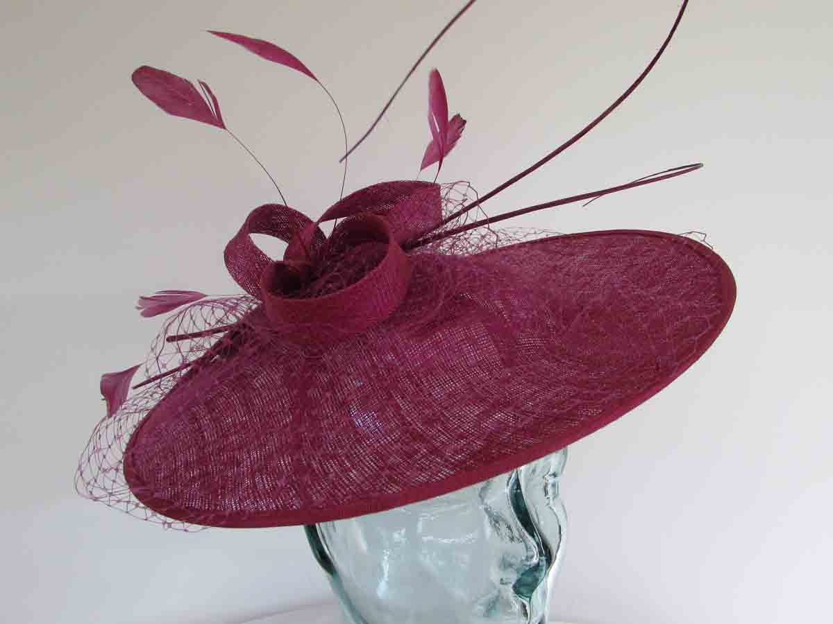 Circular hatinator with sinamay bow in berry