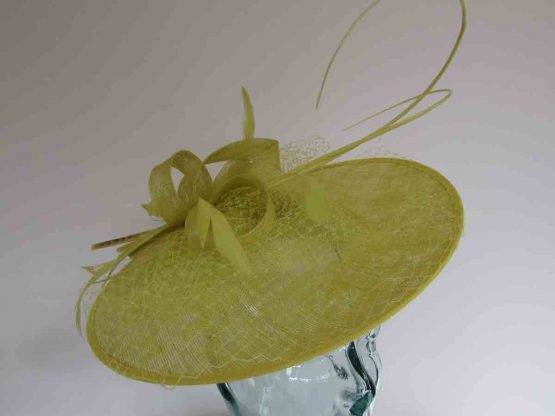 Circular hatinator with sinamay bow in citrus lime