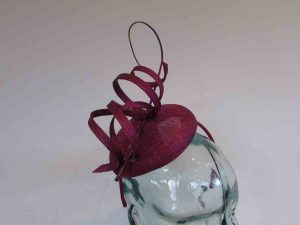 Pillbox fascinator with sinamay swirls in berry