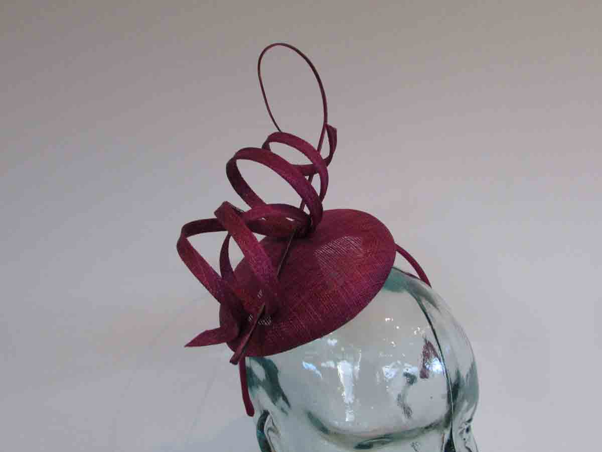 Pillbox fascinator with sinamay swirls in berry