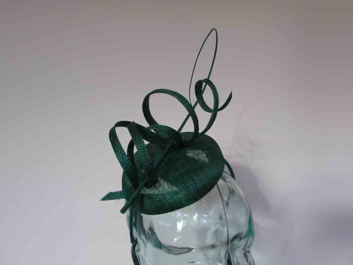Pillbox fascinator with sinamay swirls in emerald green