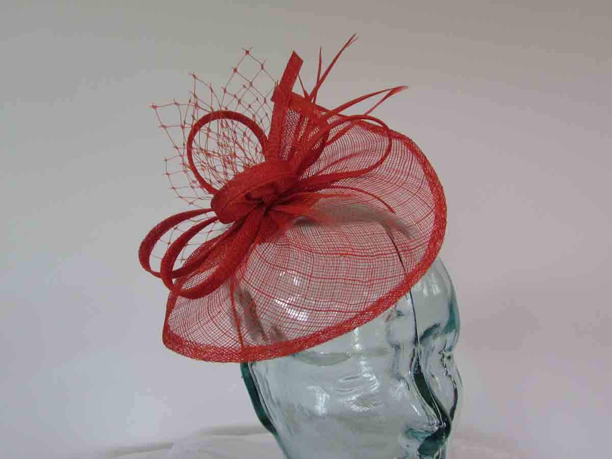 Small sinamay fascinator with netting in burnt orange