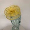 Sinamay fascinator with feahered flower in bright yellow