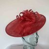 Sinamay hatinator with double feathered flower in red