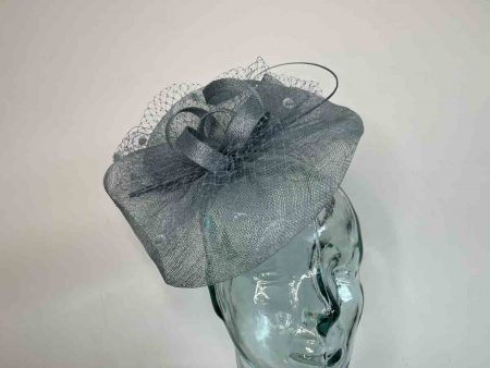 Sinamay fascinator with netting in air