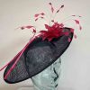 Elegant hatinator with feathered flower in navy and hot pink