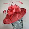 Sinamay hatinator with feathered flower in coral