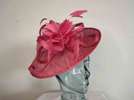 Sinamay hatinator with feathered flower in raspberry pink