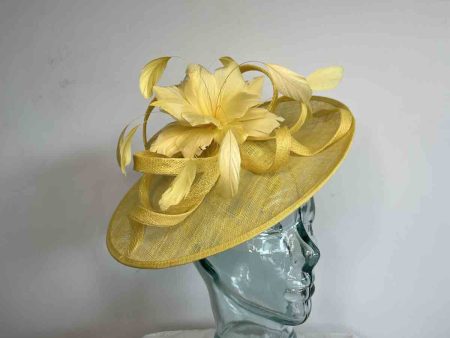 Sinamay hatinator with feathered flower in yellow