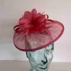 Sinamay fascinator with feathered flower in coral