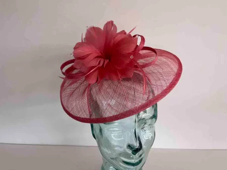 Sinamay fascinator with feathered flower in coral